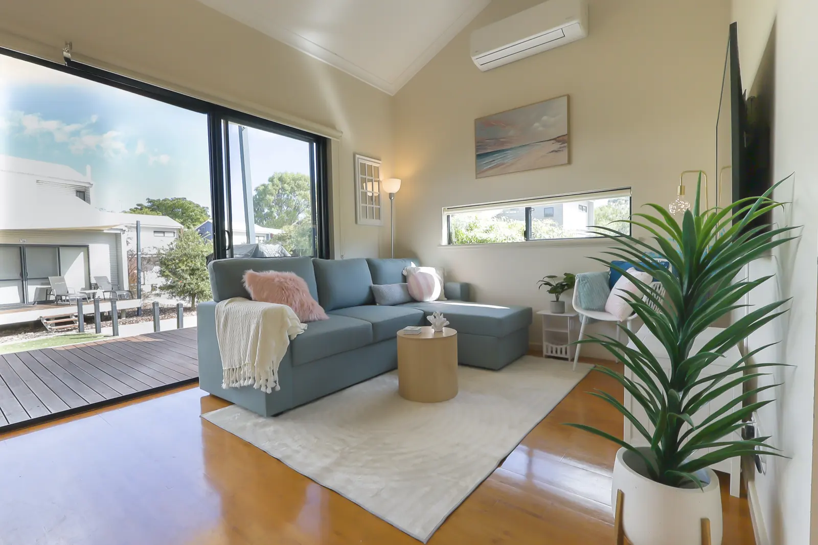 Living area with the sliding doors open onto the timber deck