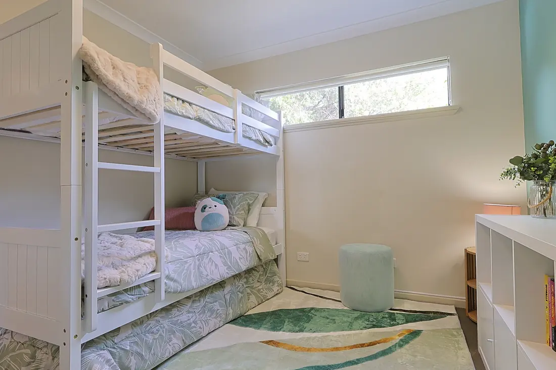 Bunk room with a roll away trundle and bookshelves